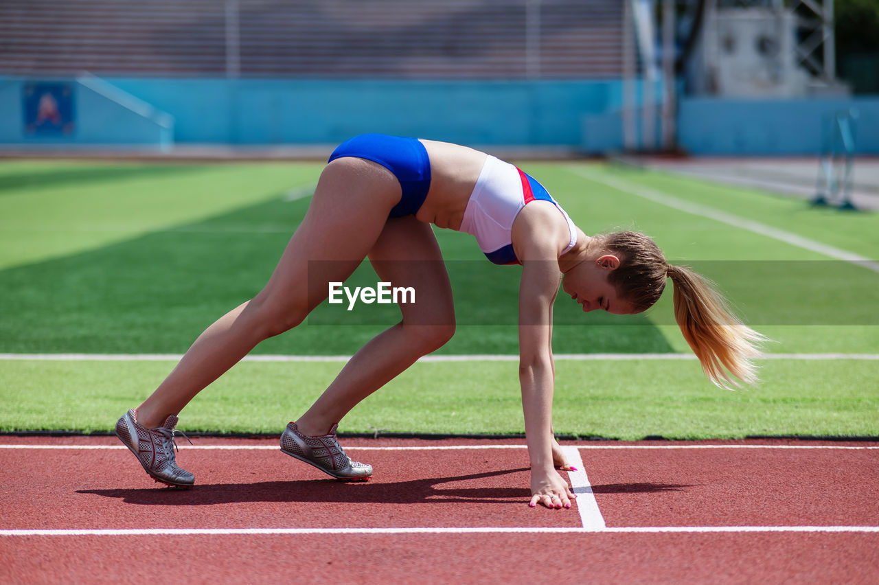 low section of woman playing soccer