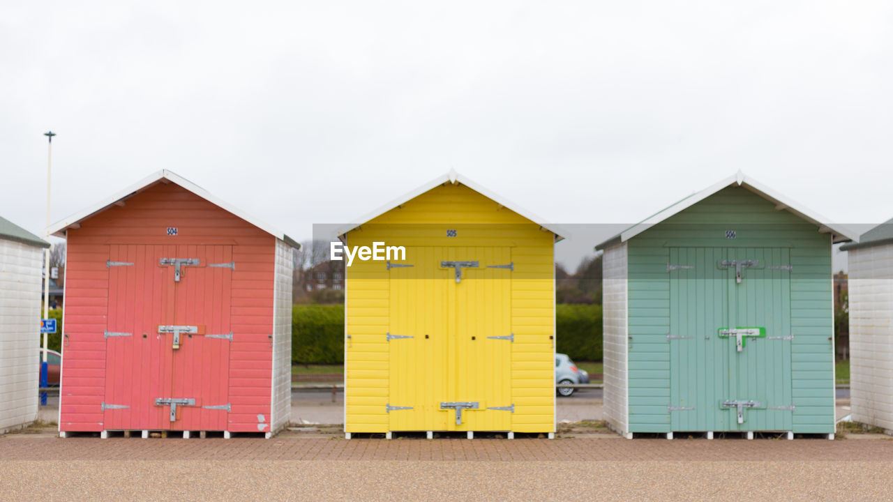 Beach huts against pale grey sky