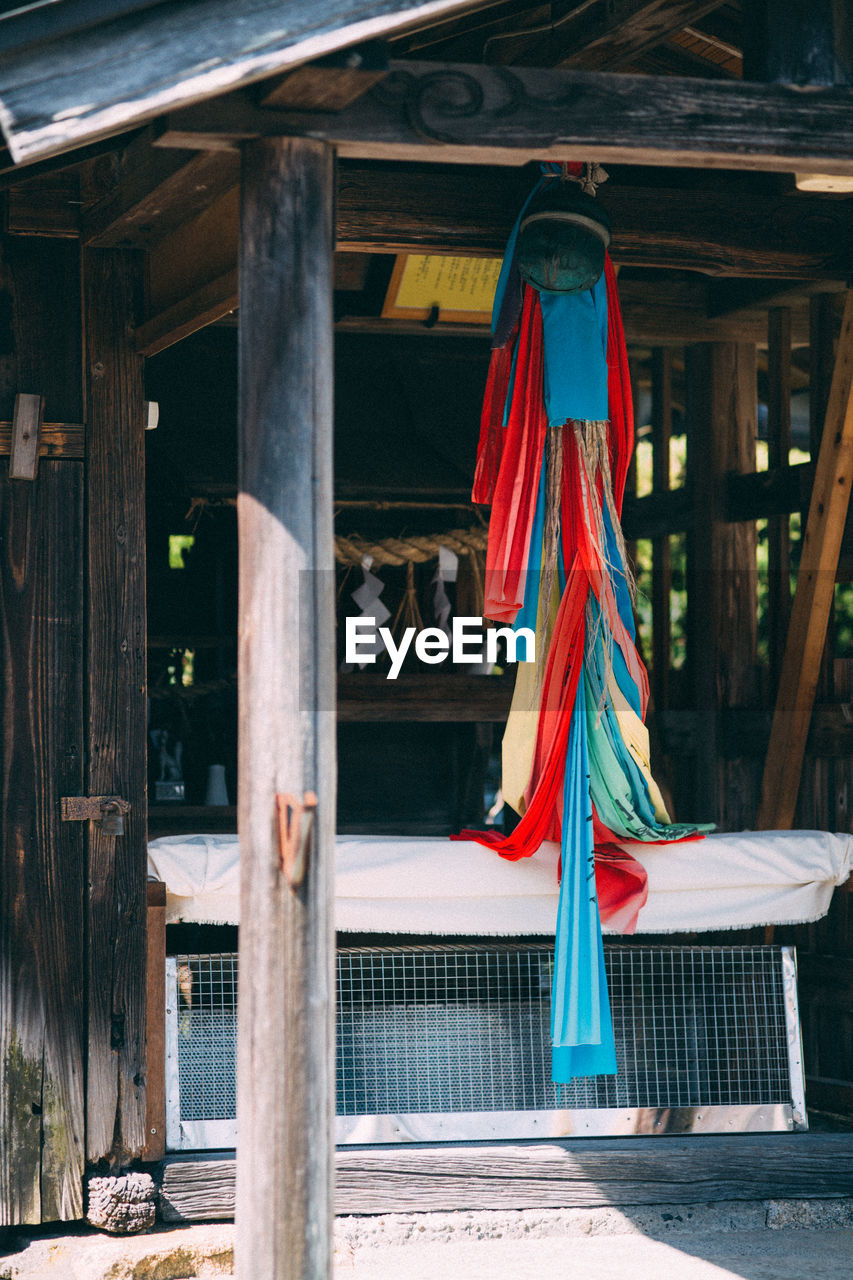 Fabrics hanging on wood at shrine