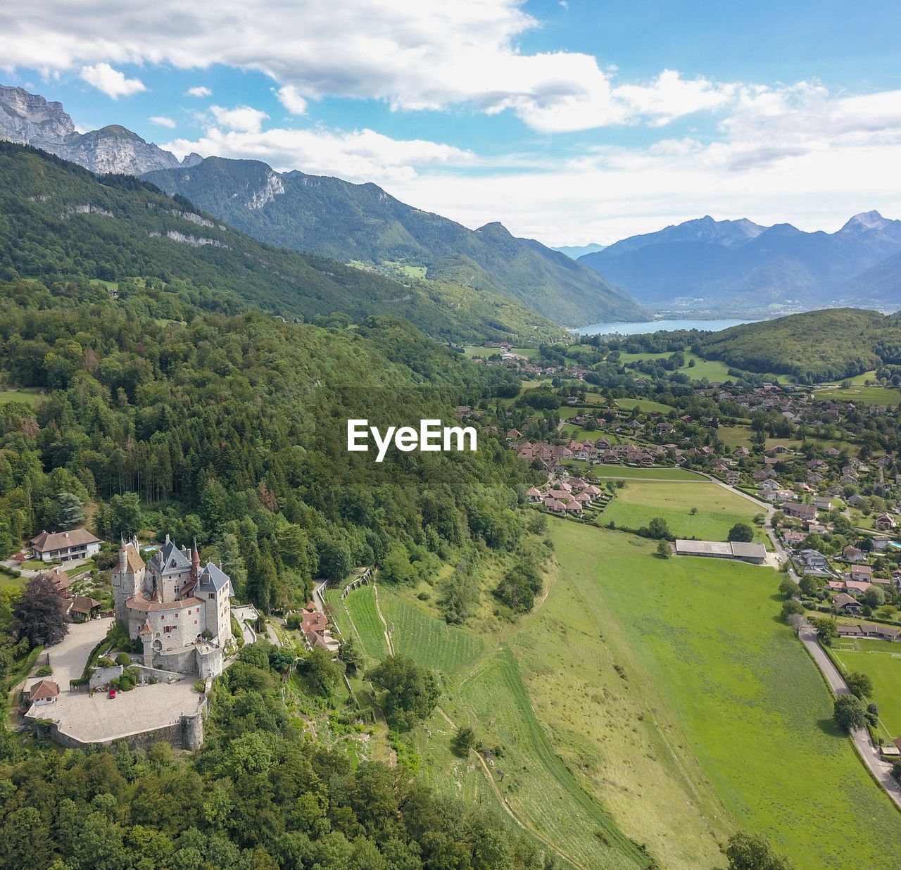 SCENIC VIEW OF GREEN LANDSCAPE AND MOUNTAIN AGAINST SKY