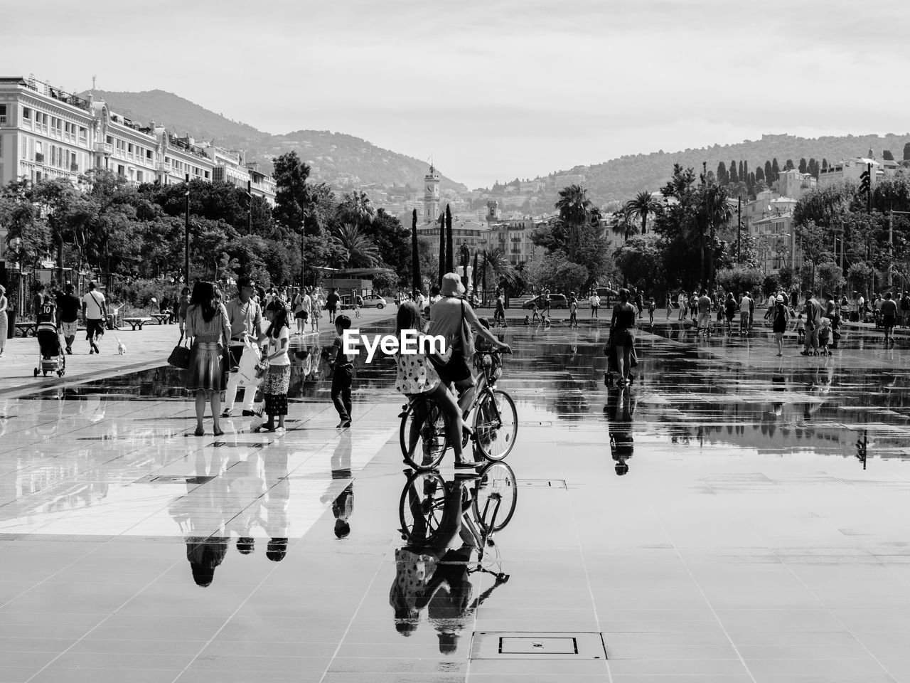 People walking in city water fountain