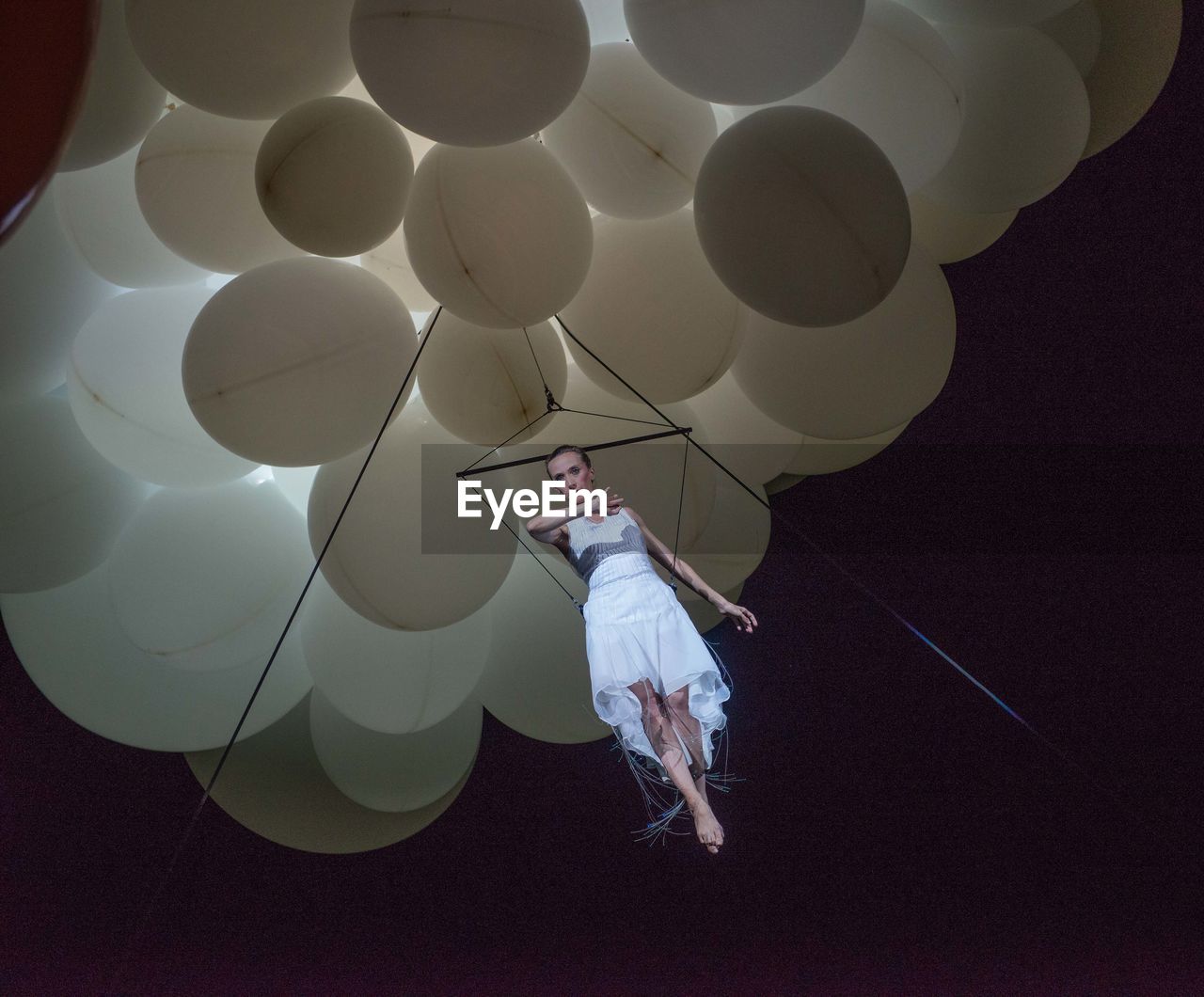Digital composite image of woman with balloon balloons