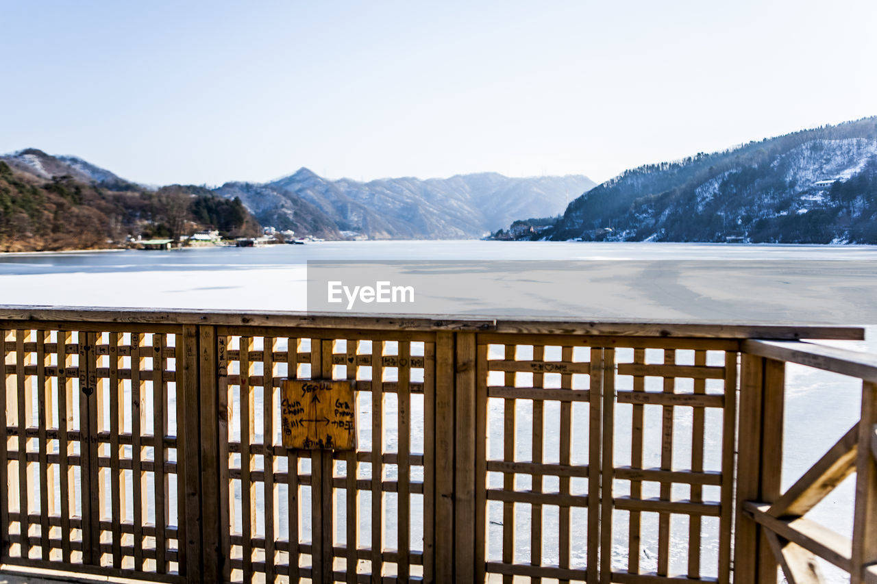 View of frozen lake against mountain range