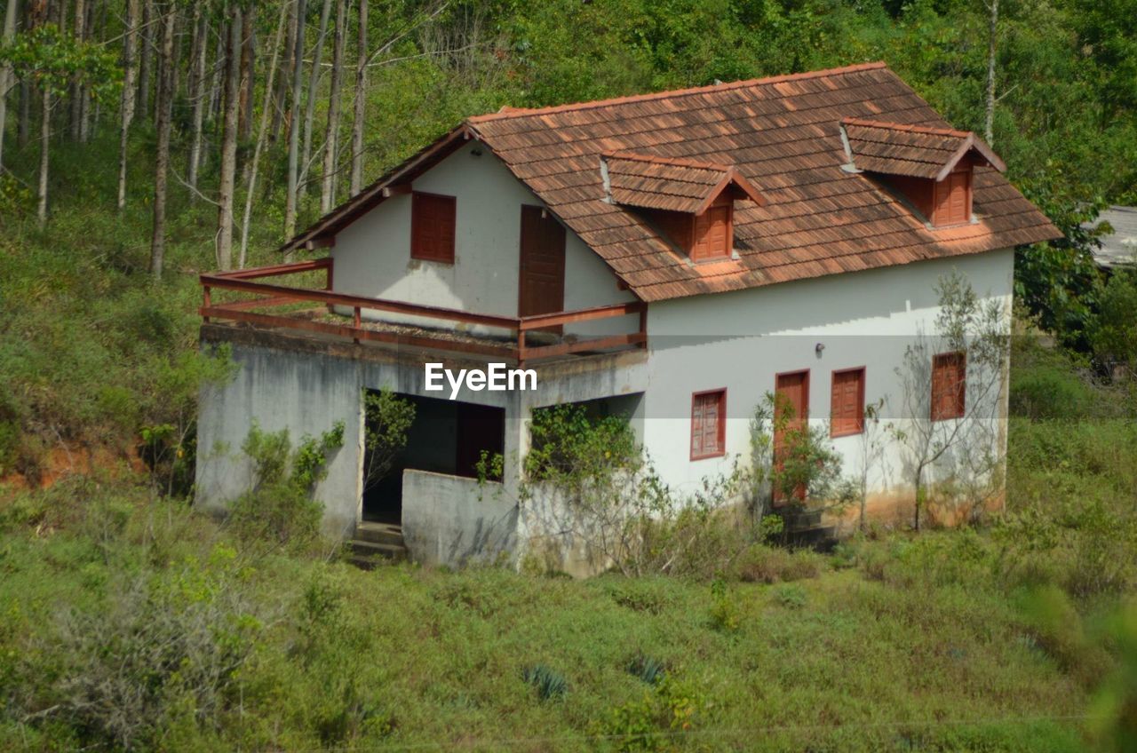 HOUSE WITH TREES IN FOREGROUND