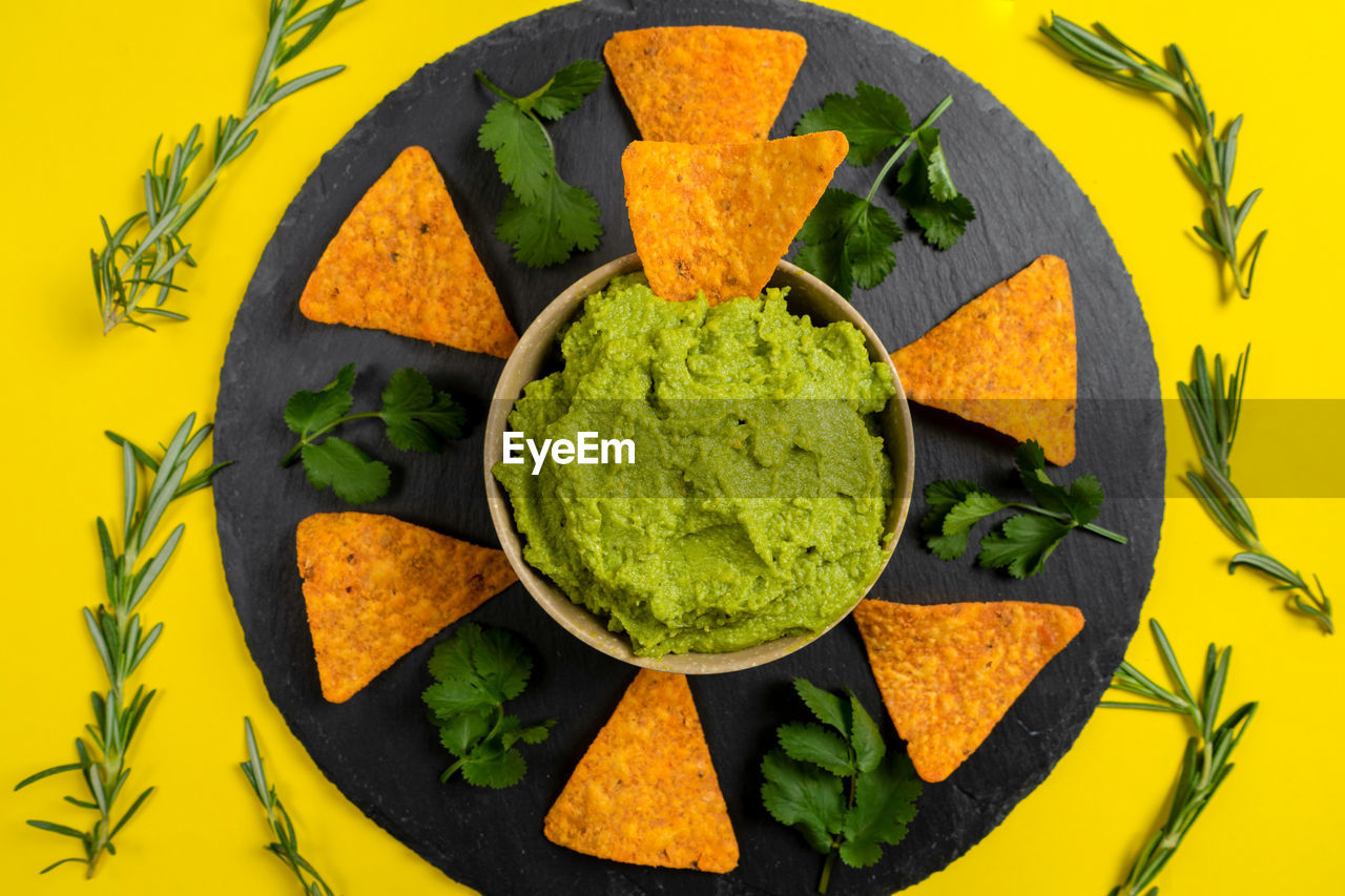 directly above shot of food in bowl on yellow background