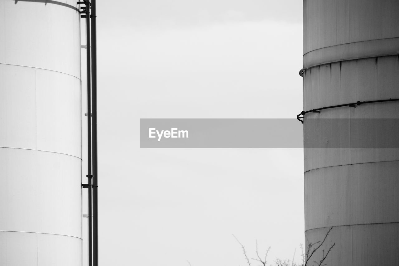 Low angle view of storage tank against sky