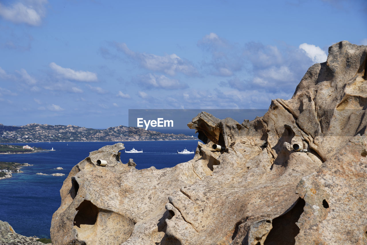 Panoramic view of rocks on beach against sky