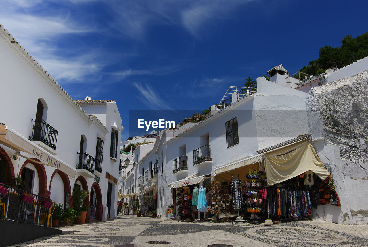 Street amidst buildings in city against sky