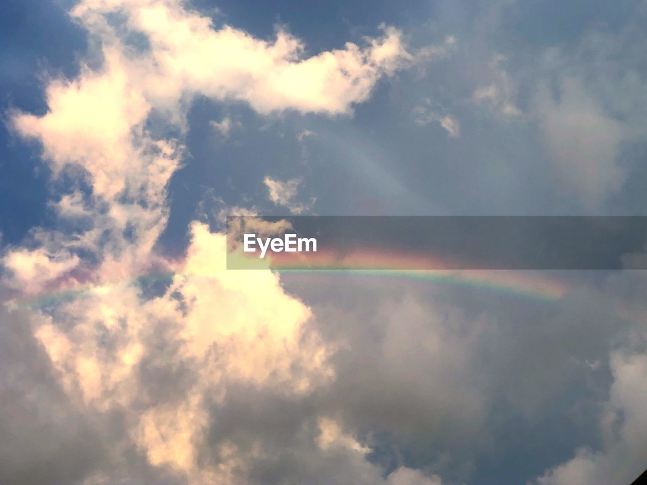 LOW ANGLE VIEW OF RAINBOW AGAINST SKY DURING SUNSET