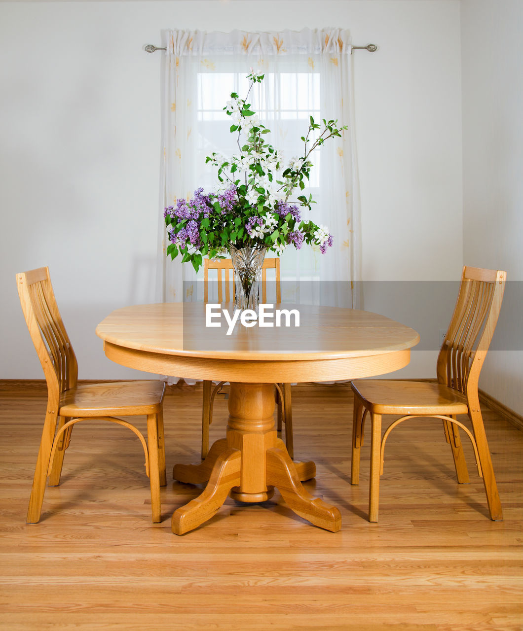 POTTED PLANT ON TABLE AGAINST WALL