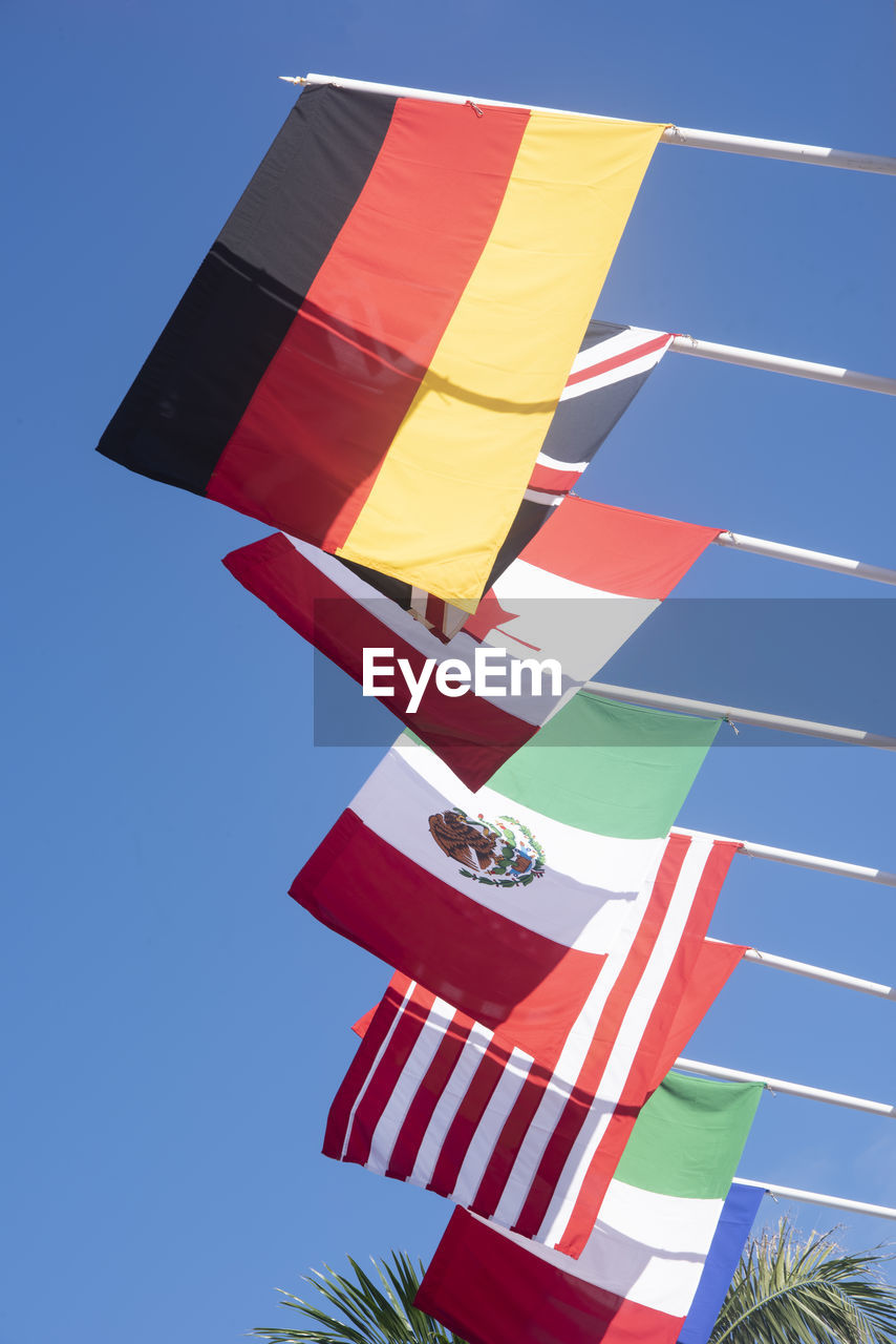 The national flags of germany, england, canada, mexico, united states, and italy flying 