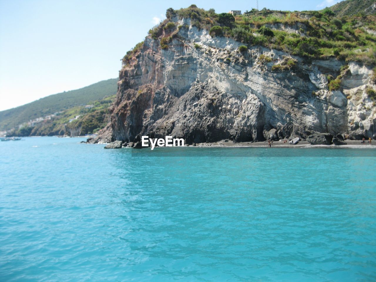 Scenic view of sea and mountains against sky