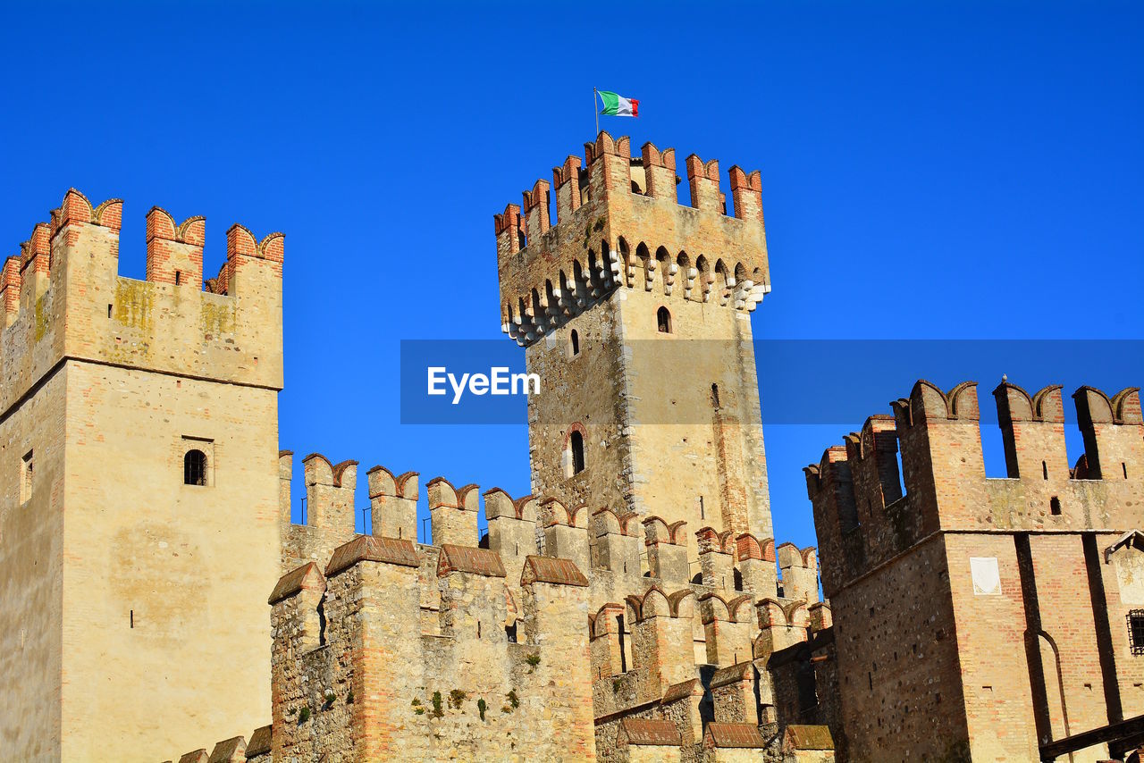 Low angle view of historic building against blue sky