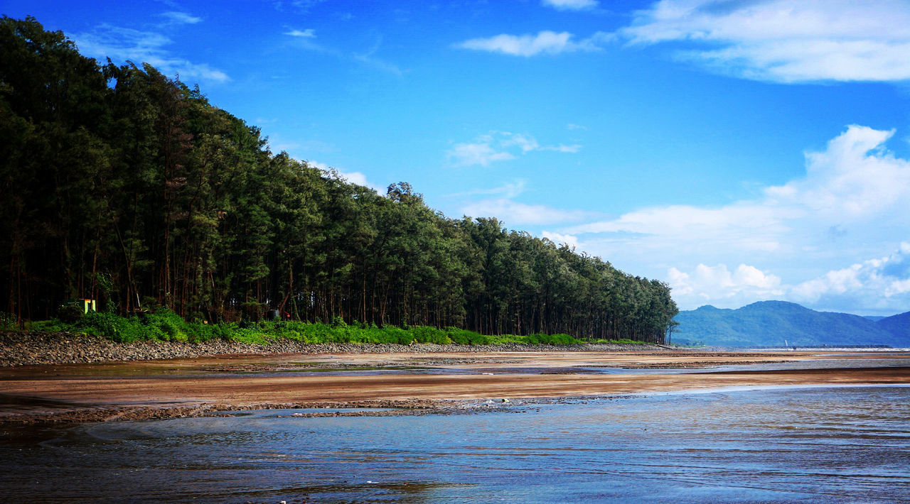 View of calm sea against mountain range