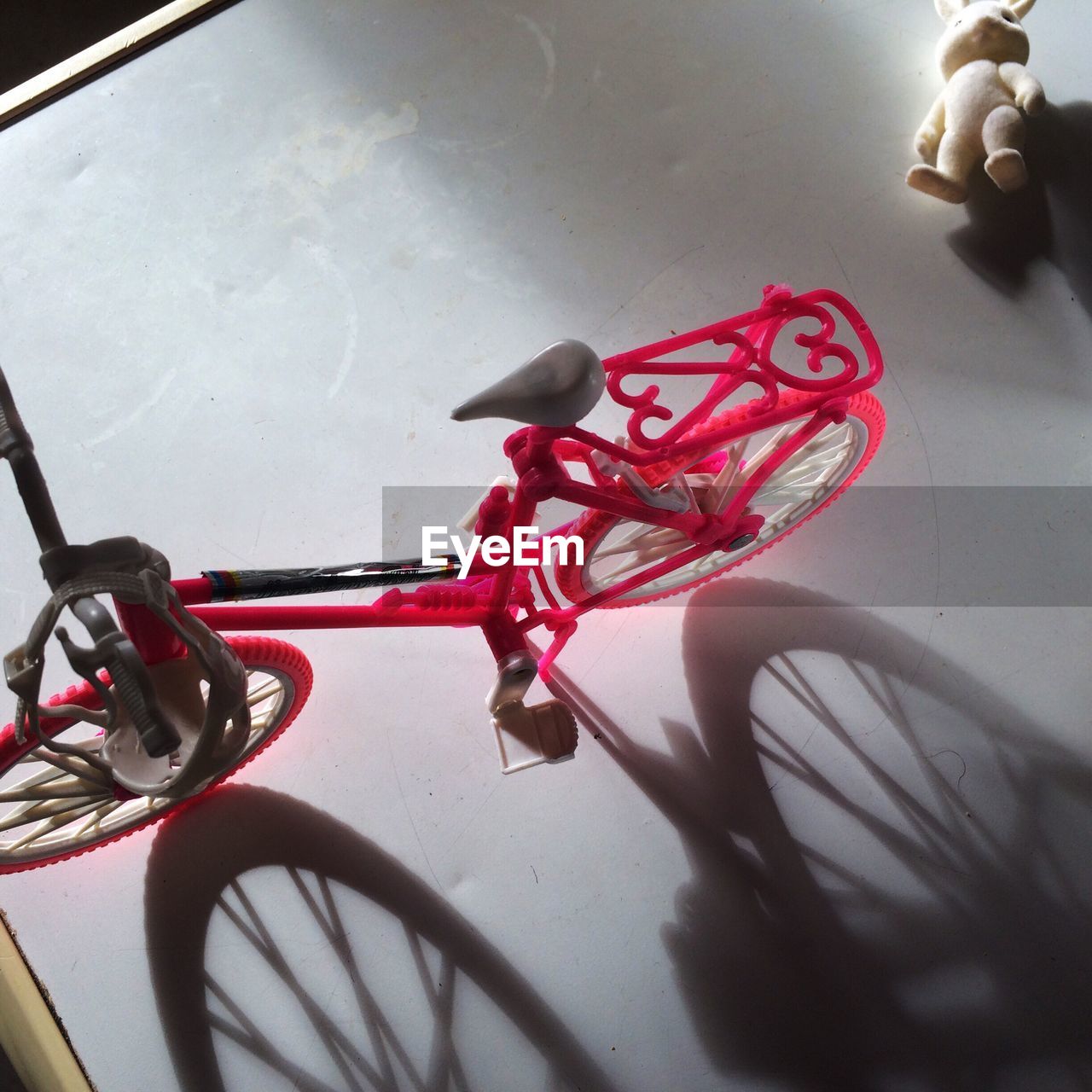 HIGH ANGLE VIEW OF BICYCLE ON RED FLOOR