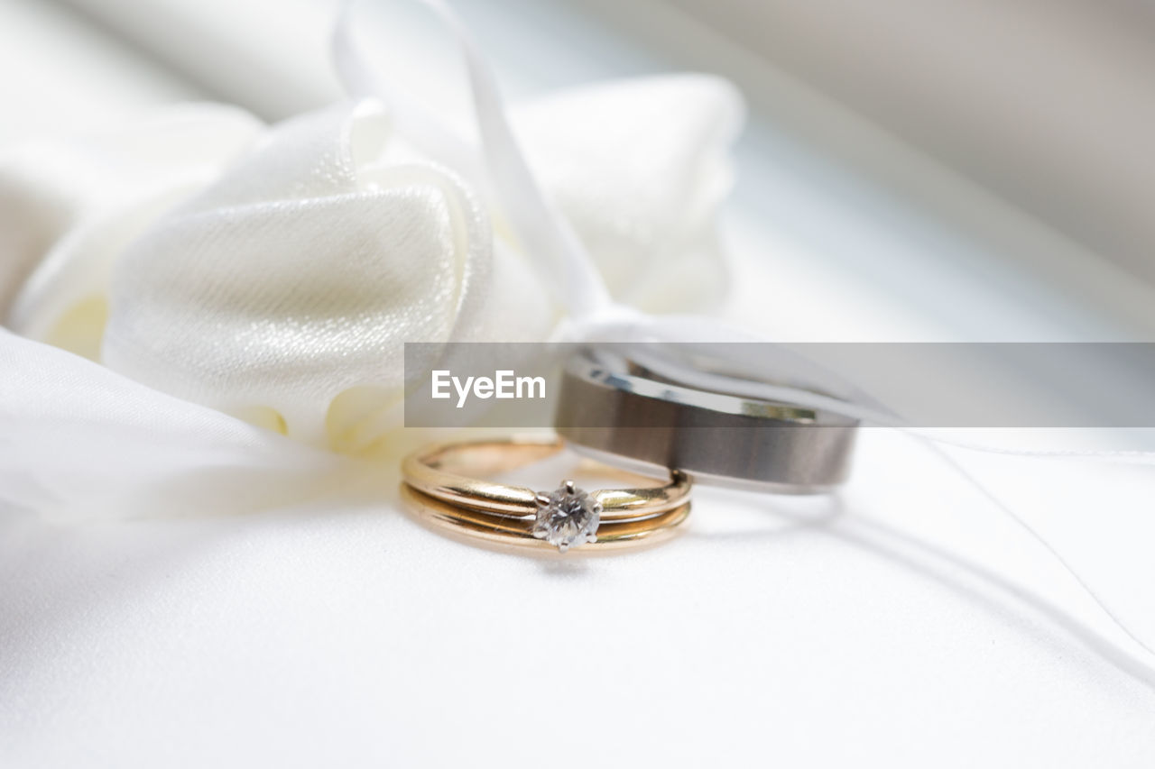 Close-up of wedding rings on table