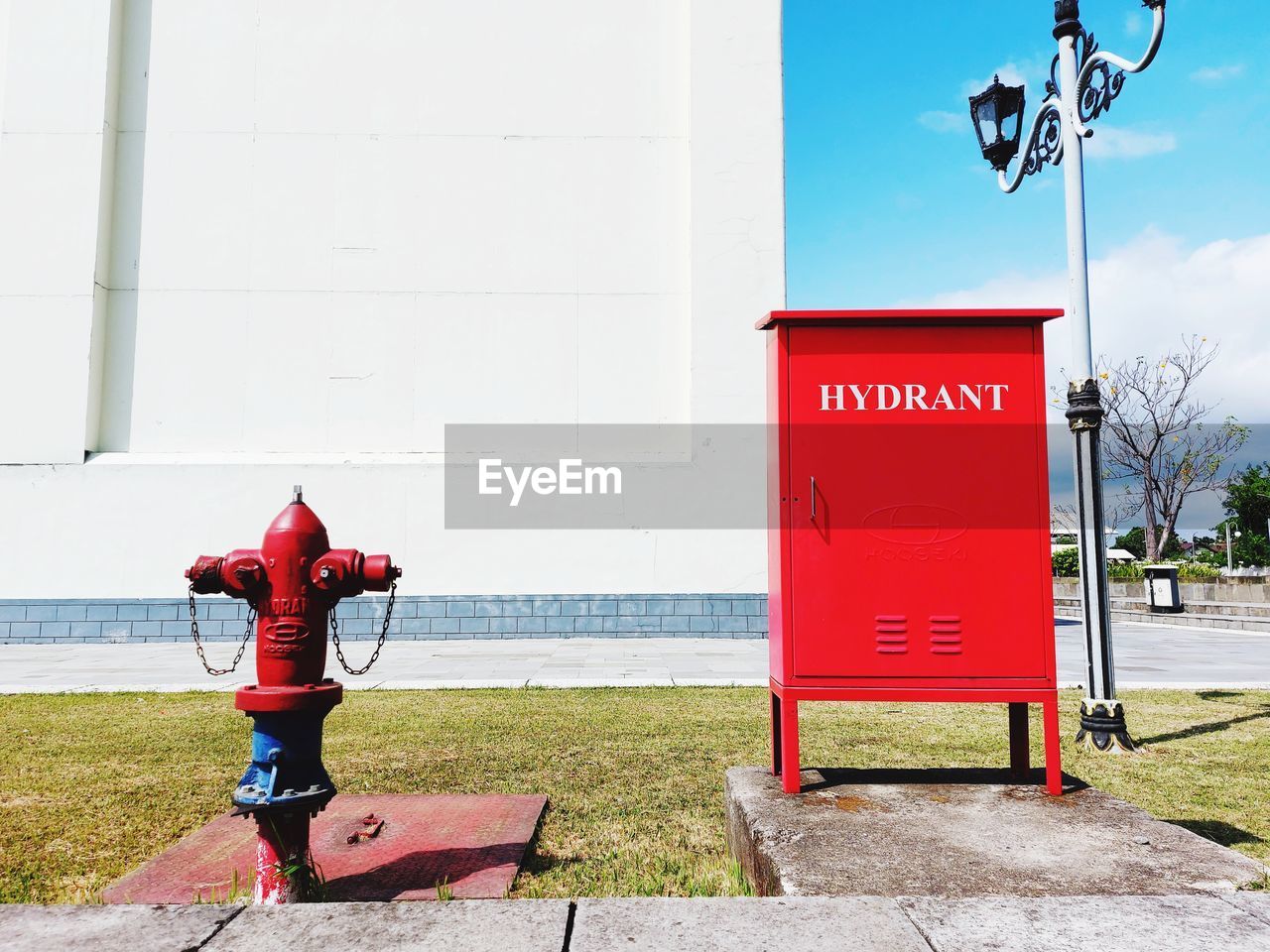 Low angle view of hydrant fire protection standing against wall of building