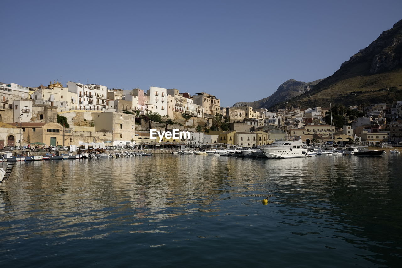 Boats on sea at castellammare del golfo