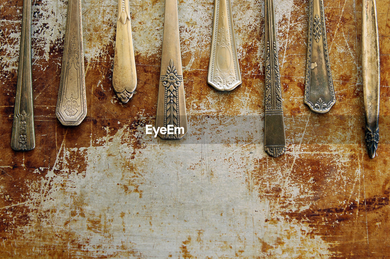 Close-up of spoons on old table