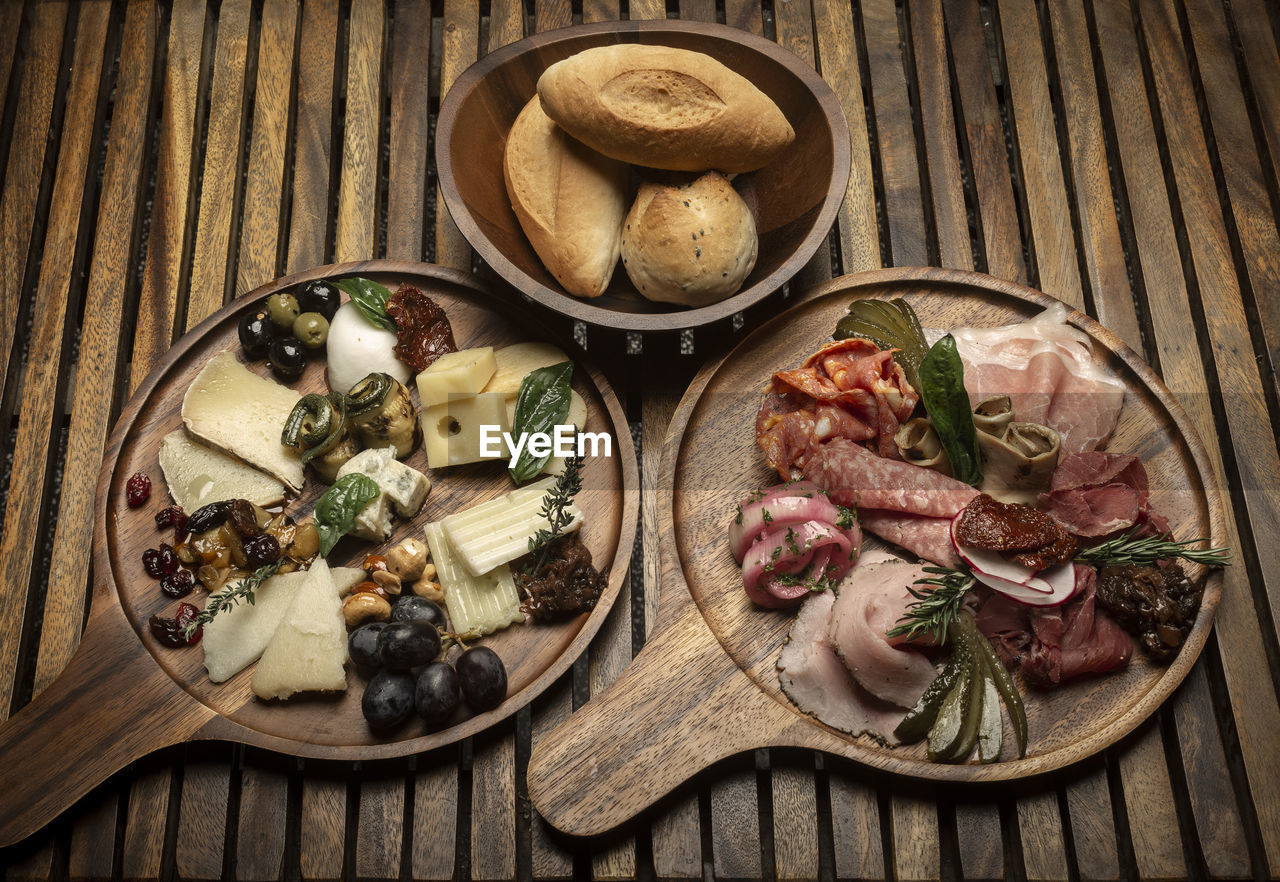 food and drink, food, freshness, healthy eating, vegetable, high angle view, indoors, no people, dish, still life, wellbeing, table, meat, plate, wood, meal, bowl, directly above, fruit, herb, raw food, cheese