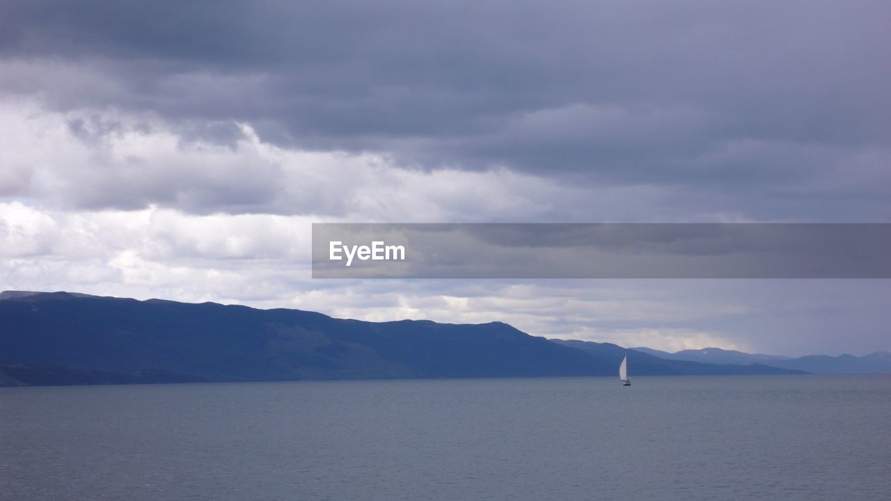 Scenic view of mountains against cloudy sky