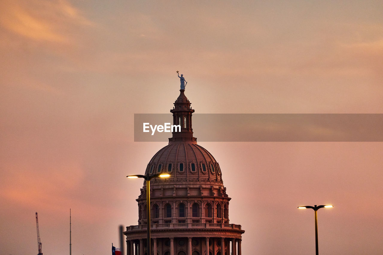 Low angle view of congress building against sky during sunset