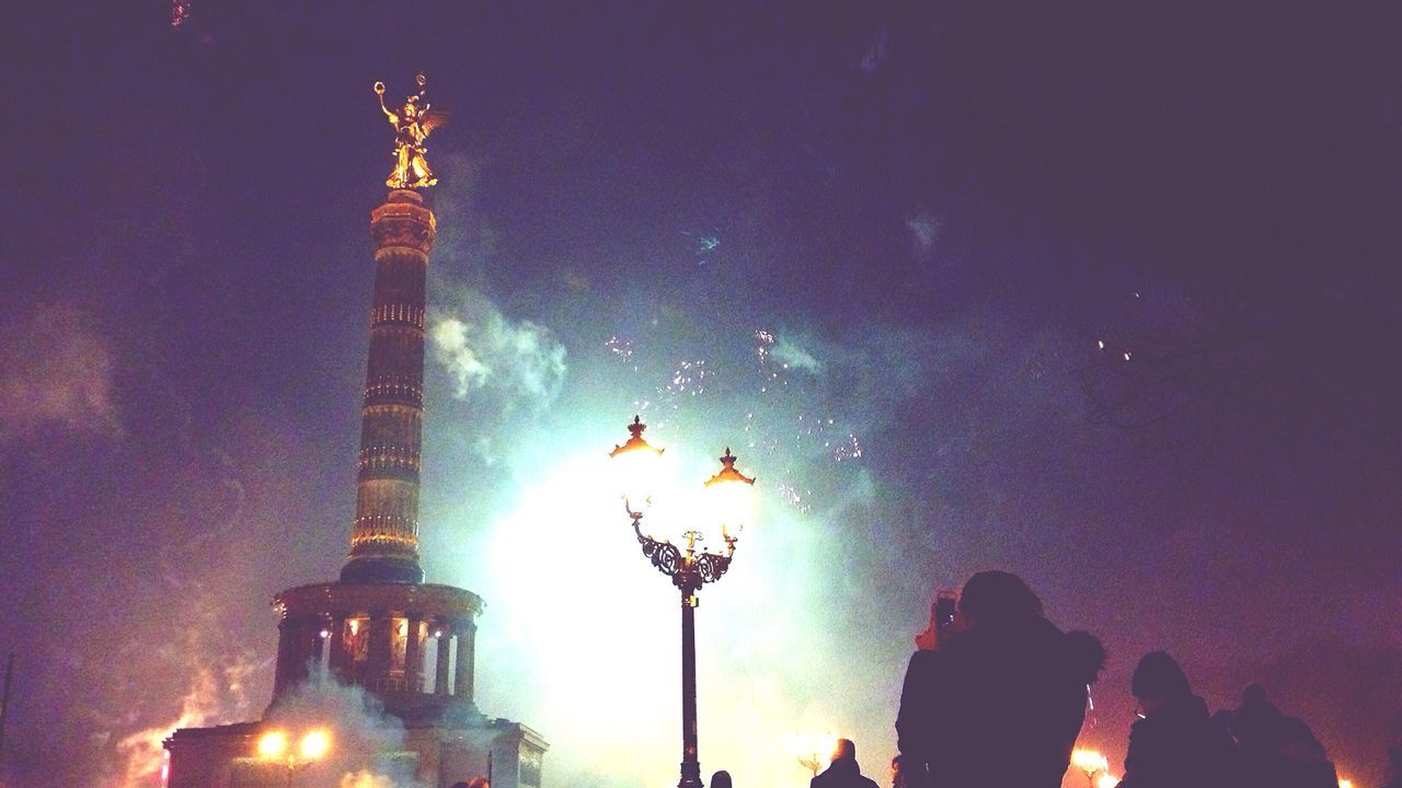 Silhouette people watching firework display at new year eve