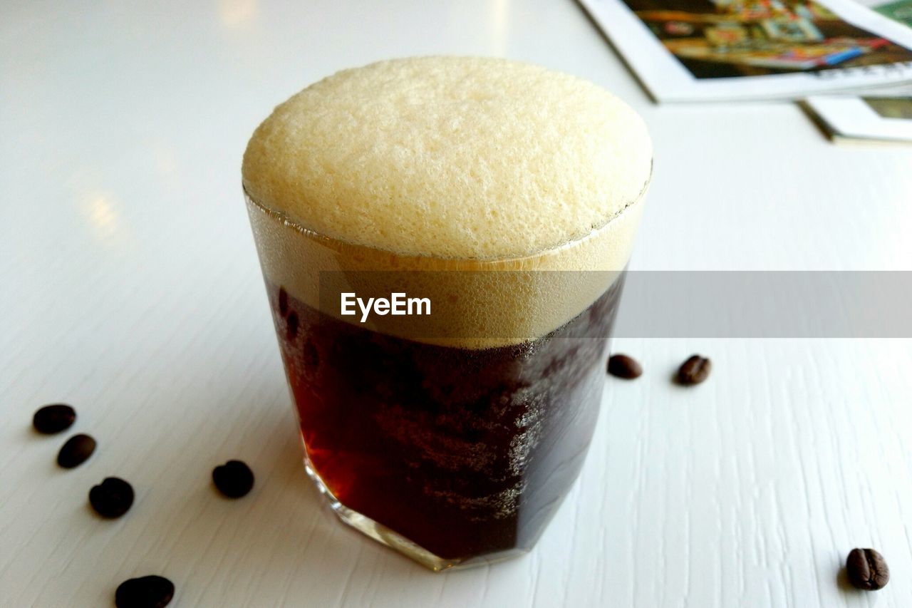 Close-up of coffee with beans on table