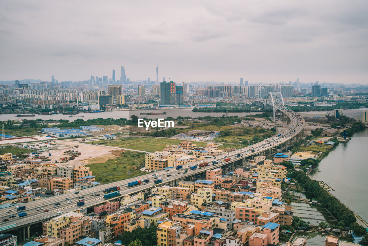 HIGH ANGLE VIEW OF BUILDINGS AND CITY AGAINST SKY