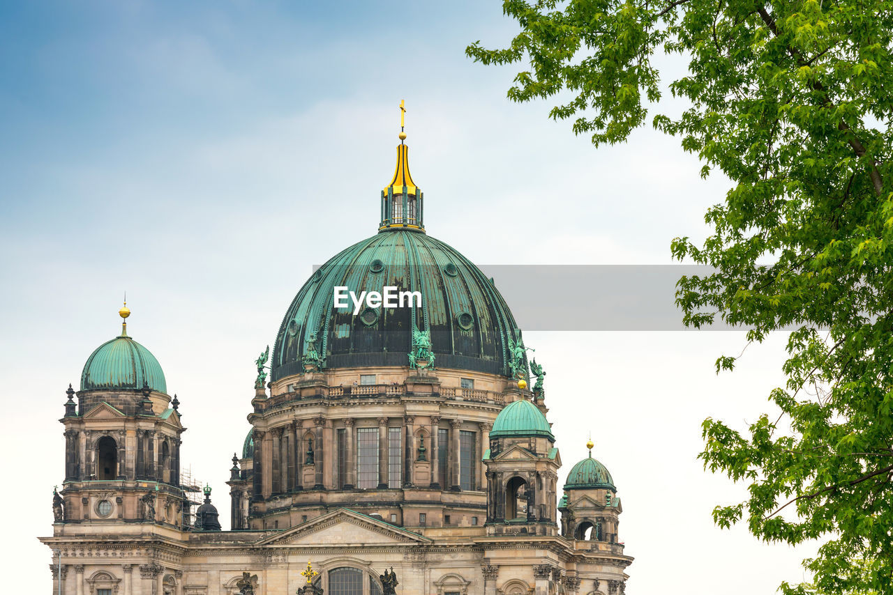 Low angle view of berlin cathedral against cloudy sky