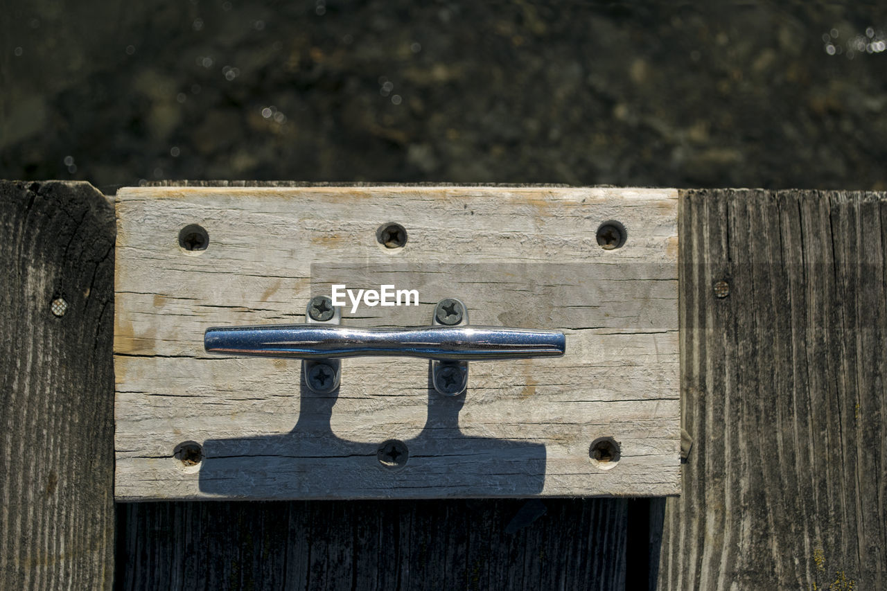 High angle view of cleat on wooden pier