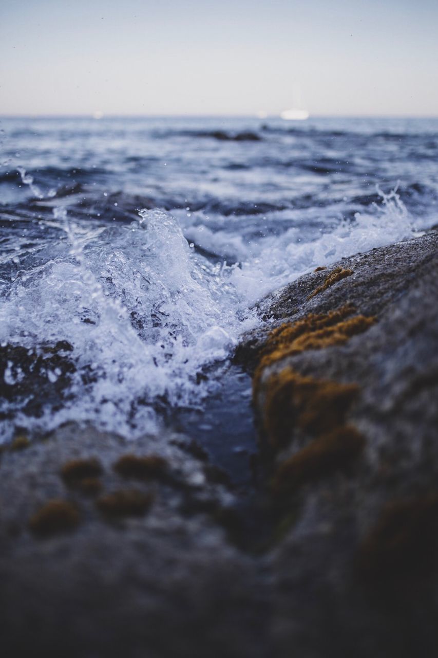 Close-up of sea waves splashing on rocks