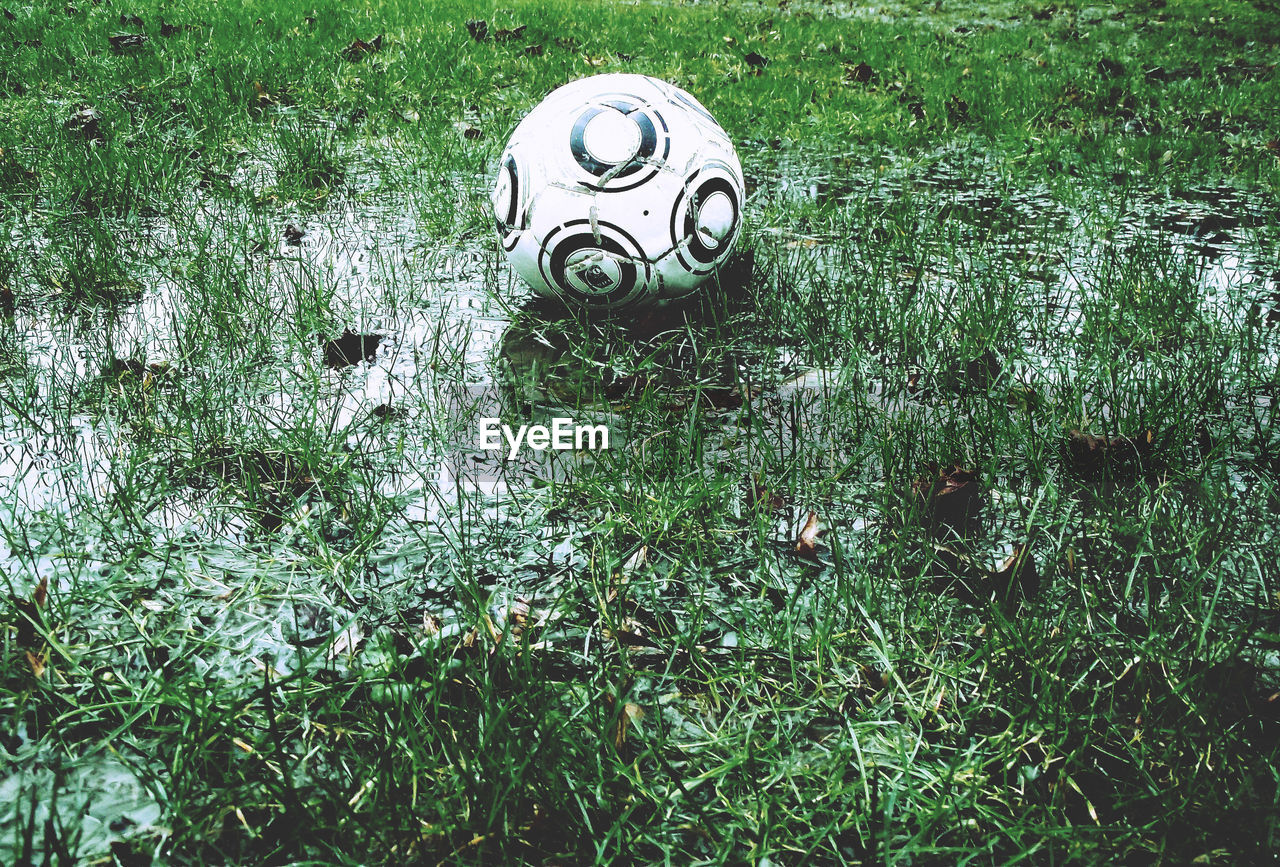High angle view of soccer ball on wet field