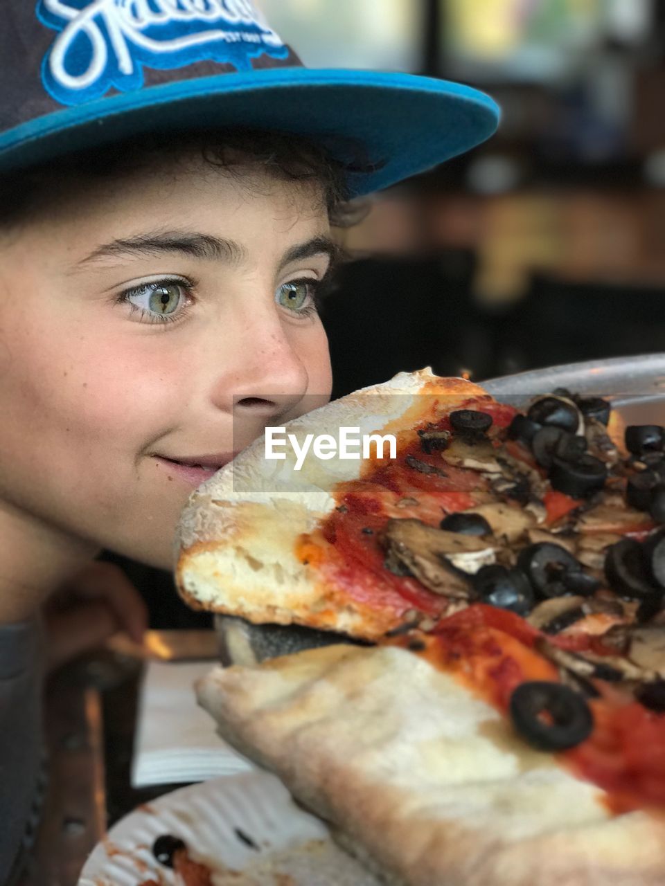 CLOSE-UP PORTRAIT OF BOY WITH MEAT