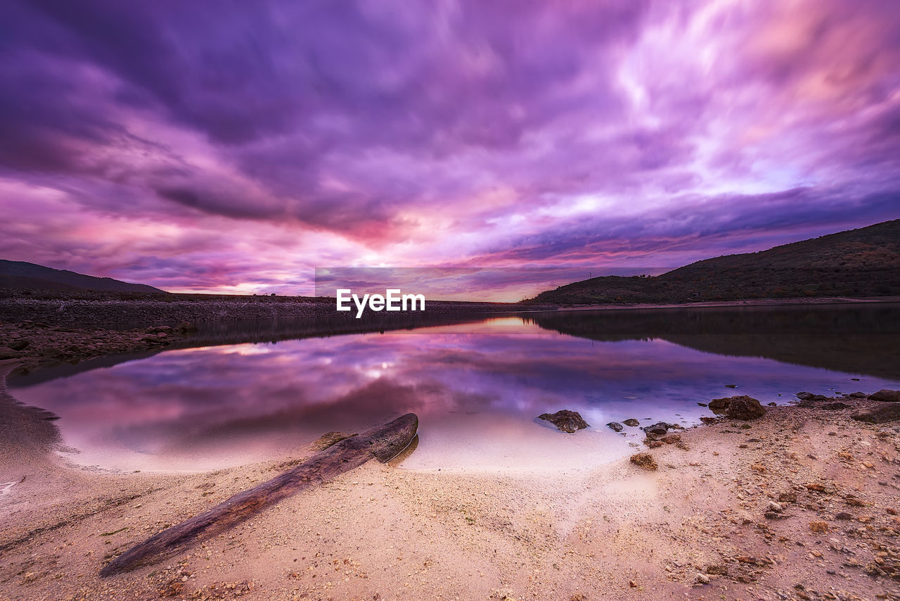 Scenic view of lake against sky during sunset