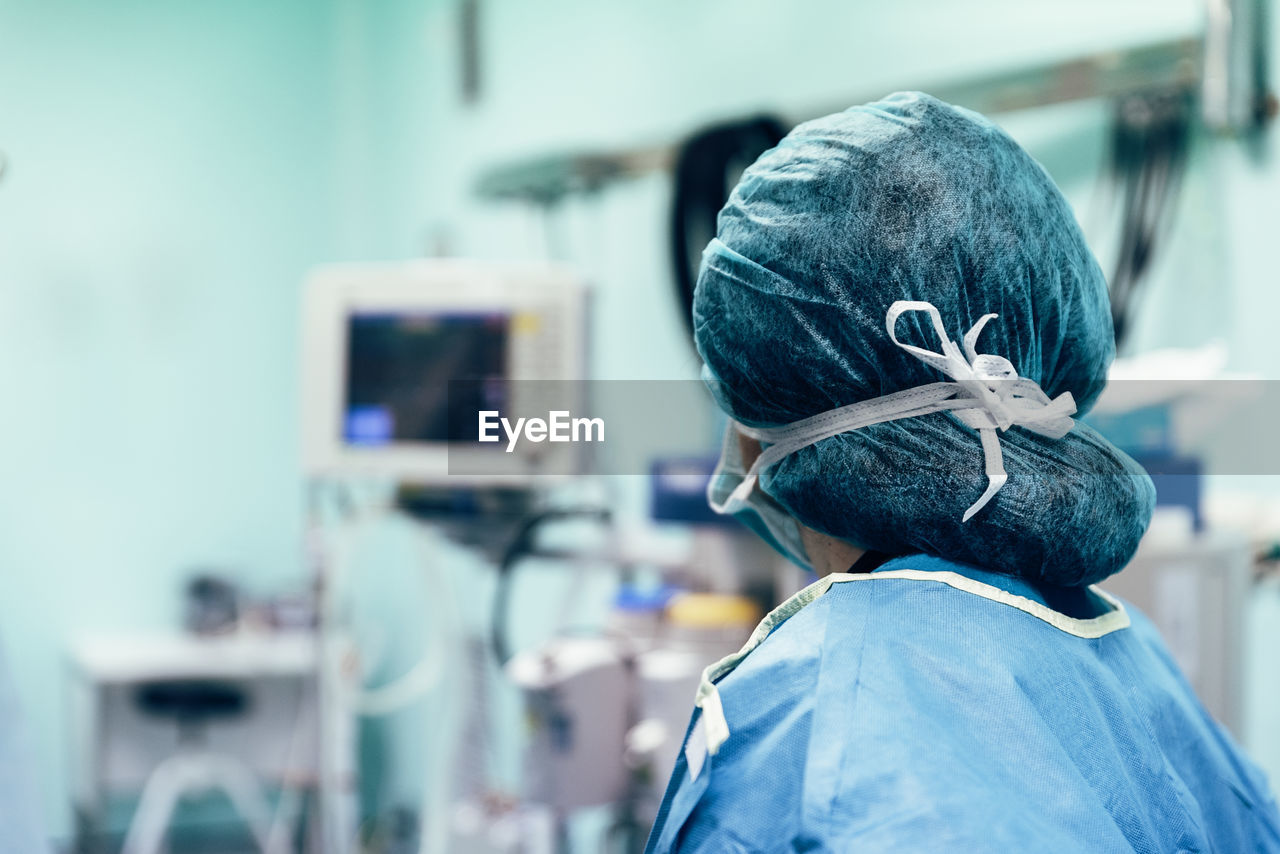 Rear view of doctor wearing surgical cap