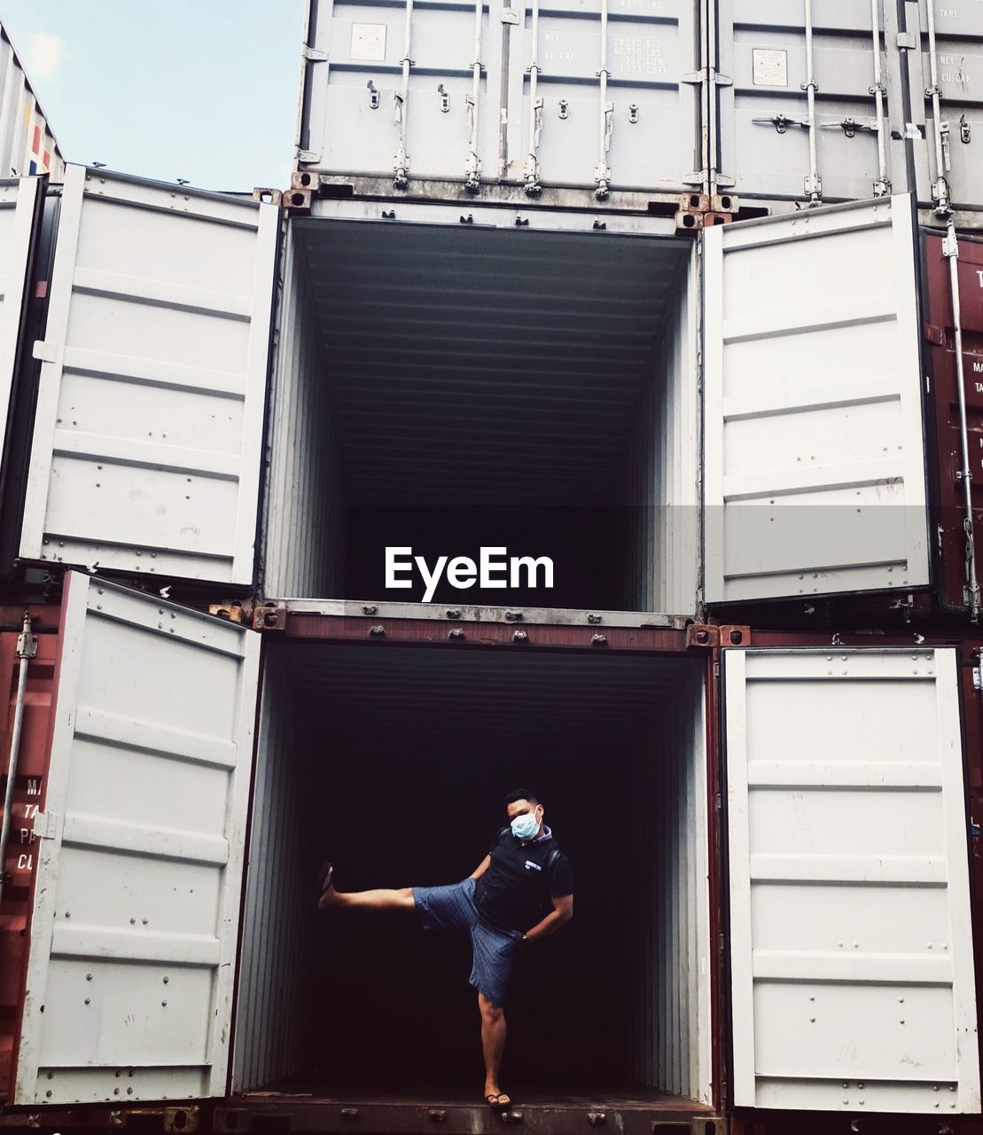 WOMAN STANDING BY BUILDING