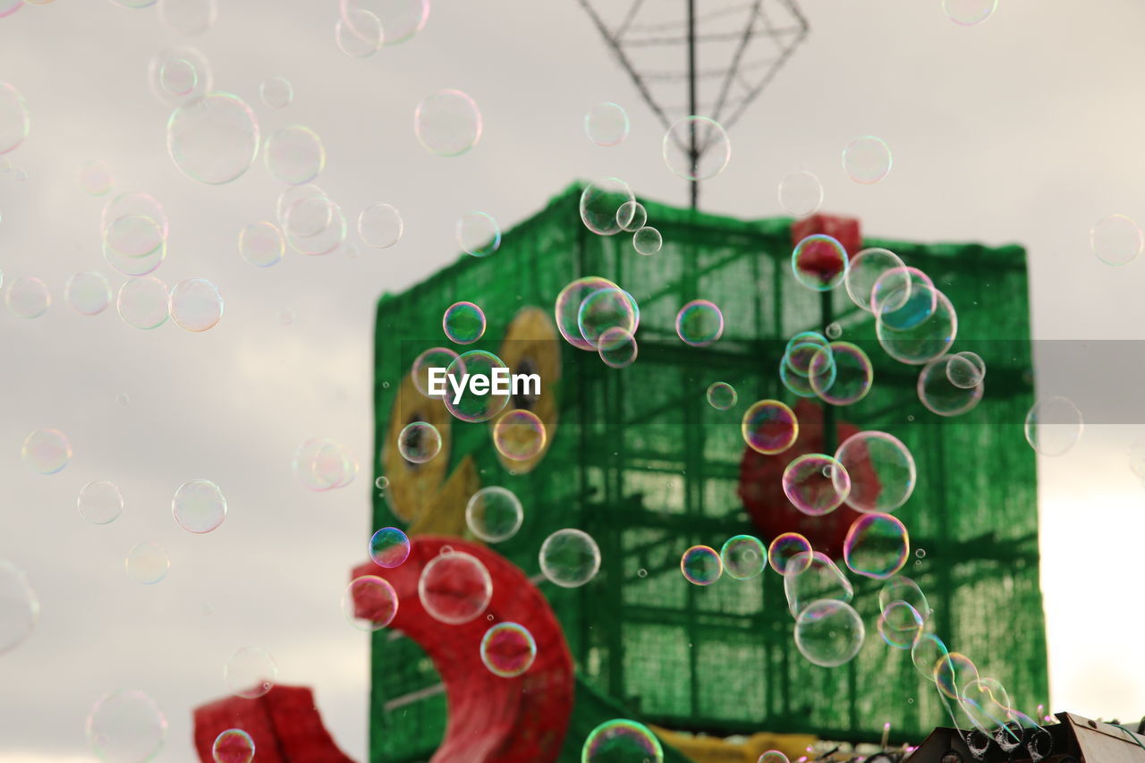 Close-up of soap bubbles seen through glass window