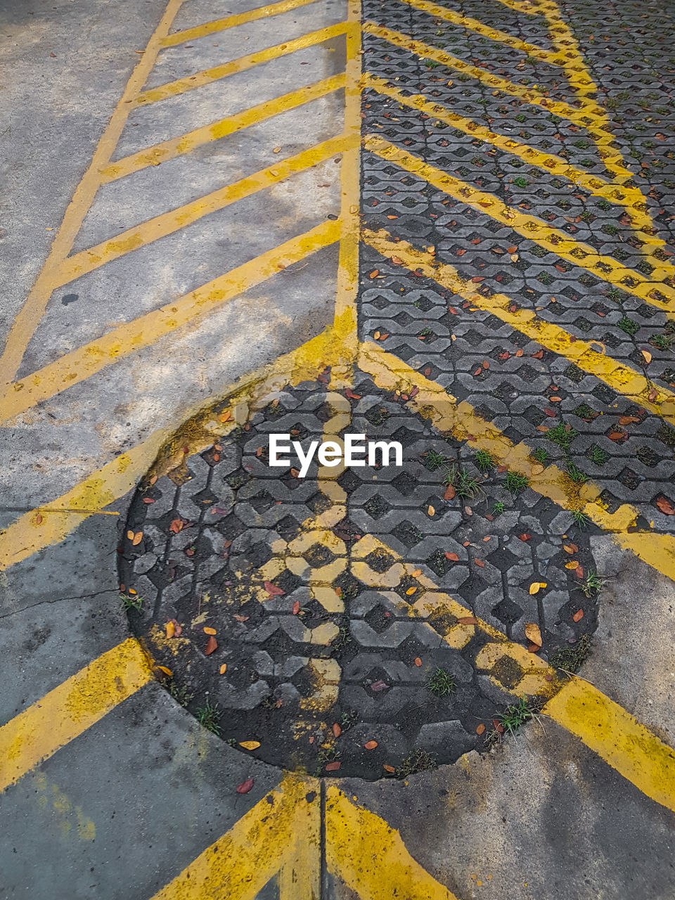 High angle view of yellow manhole on street