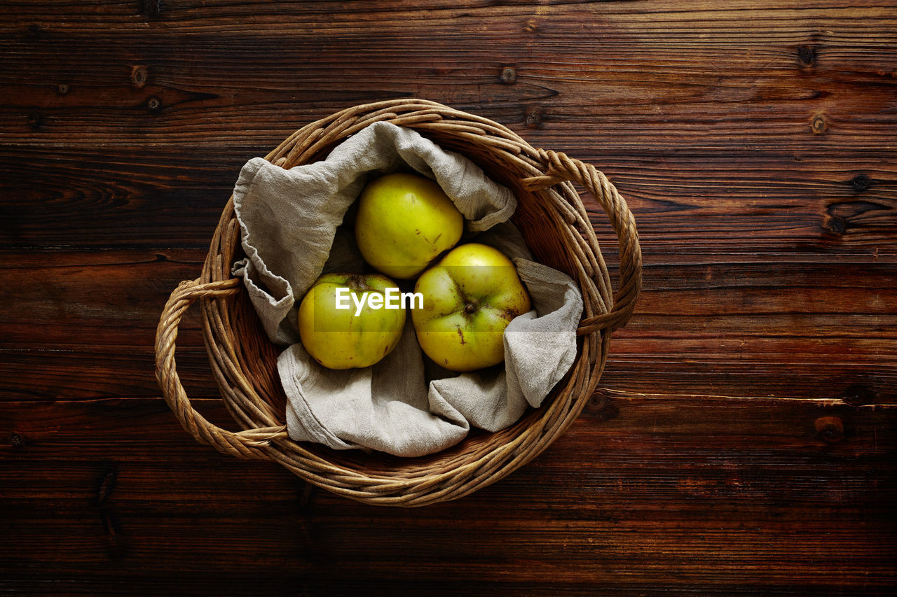 Directly above shot of fruits in wicker basket on table
