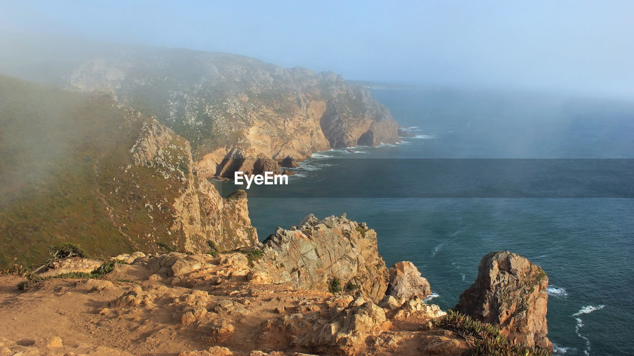 SCENIC VIEW OF ROCKS BY SEA