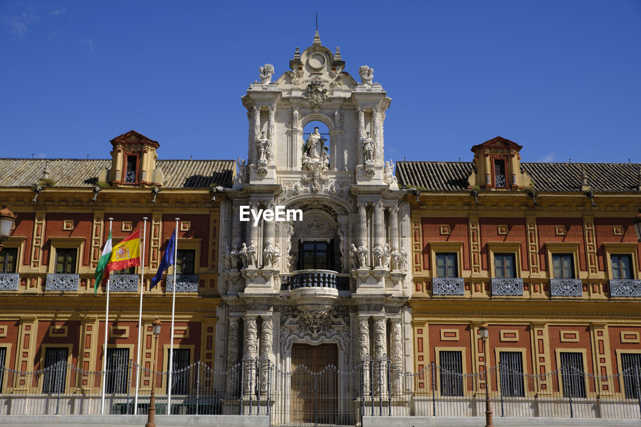 LOW ANGLE VIEW OF HISTORICAL BUILDING AGAINST BLUE SKY