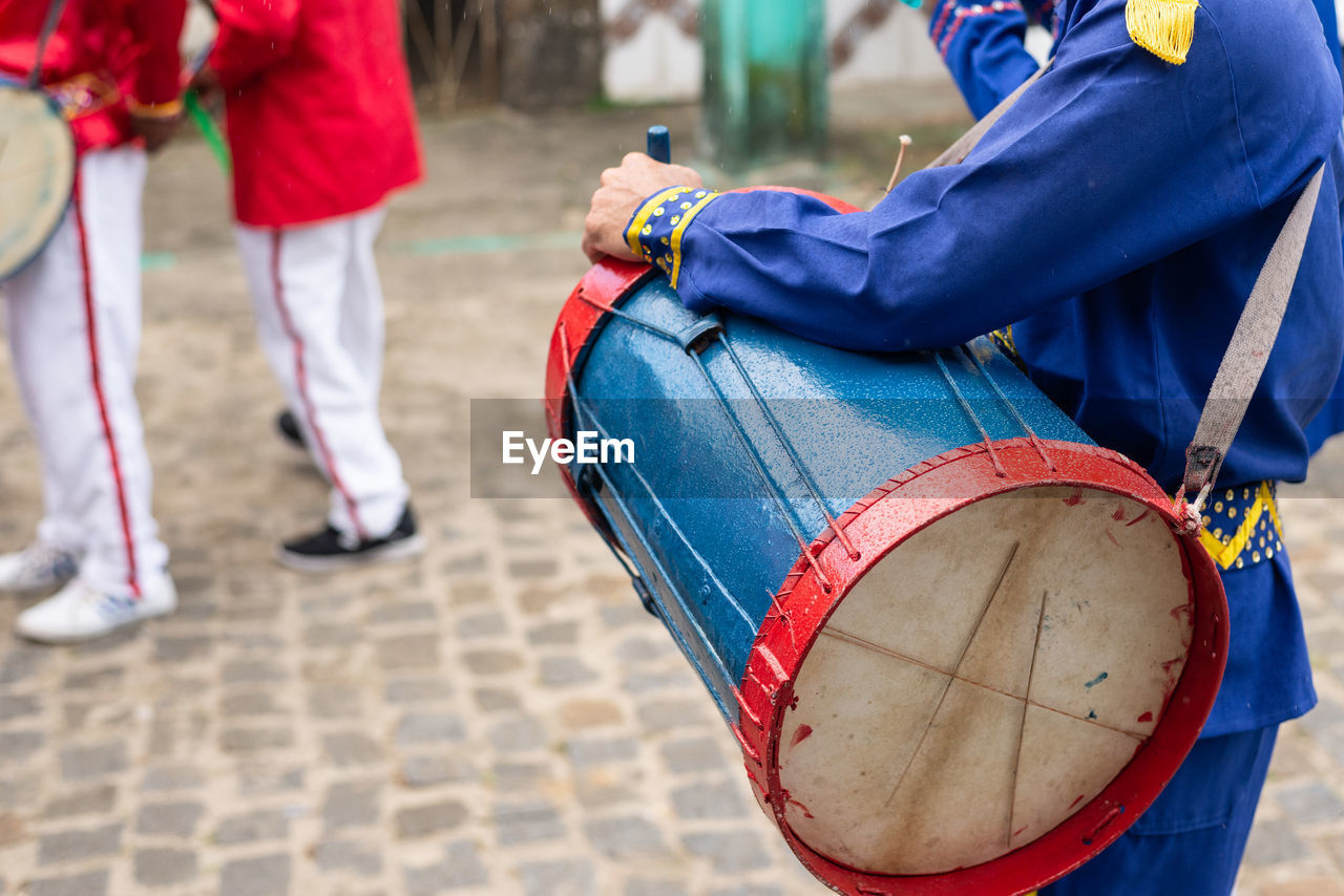 Members of the marujada and cheganca cultural group are seen playing percussion instruments 