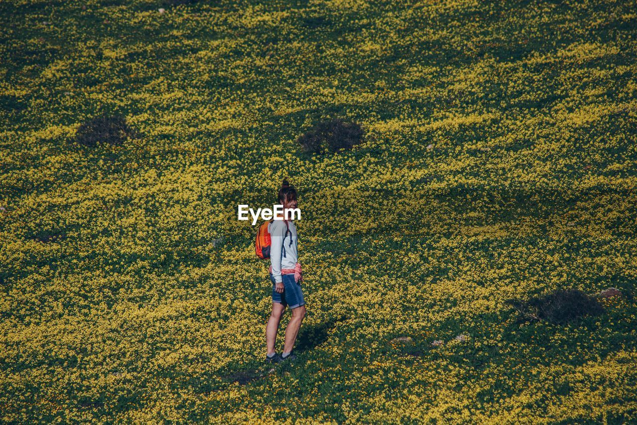 Full length of woman walking on field