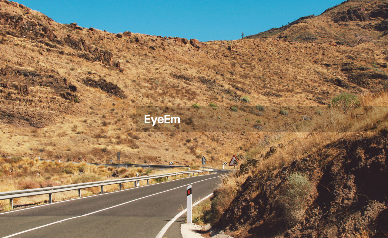 Mountain road against clear sky