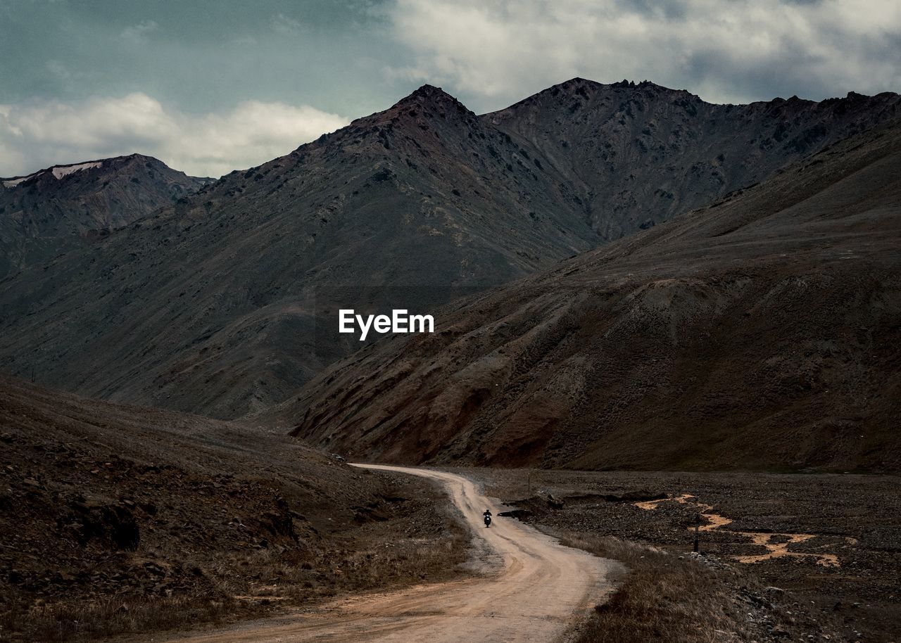 Scenic view of mountains against cloudy sky