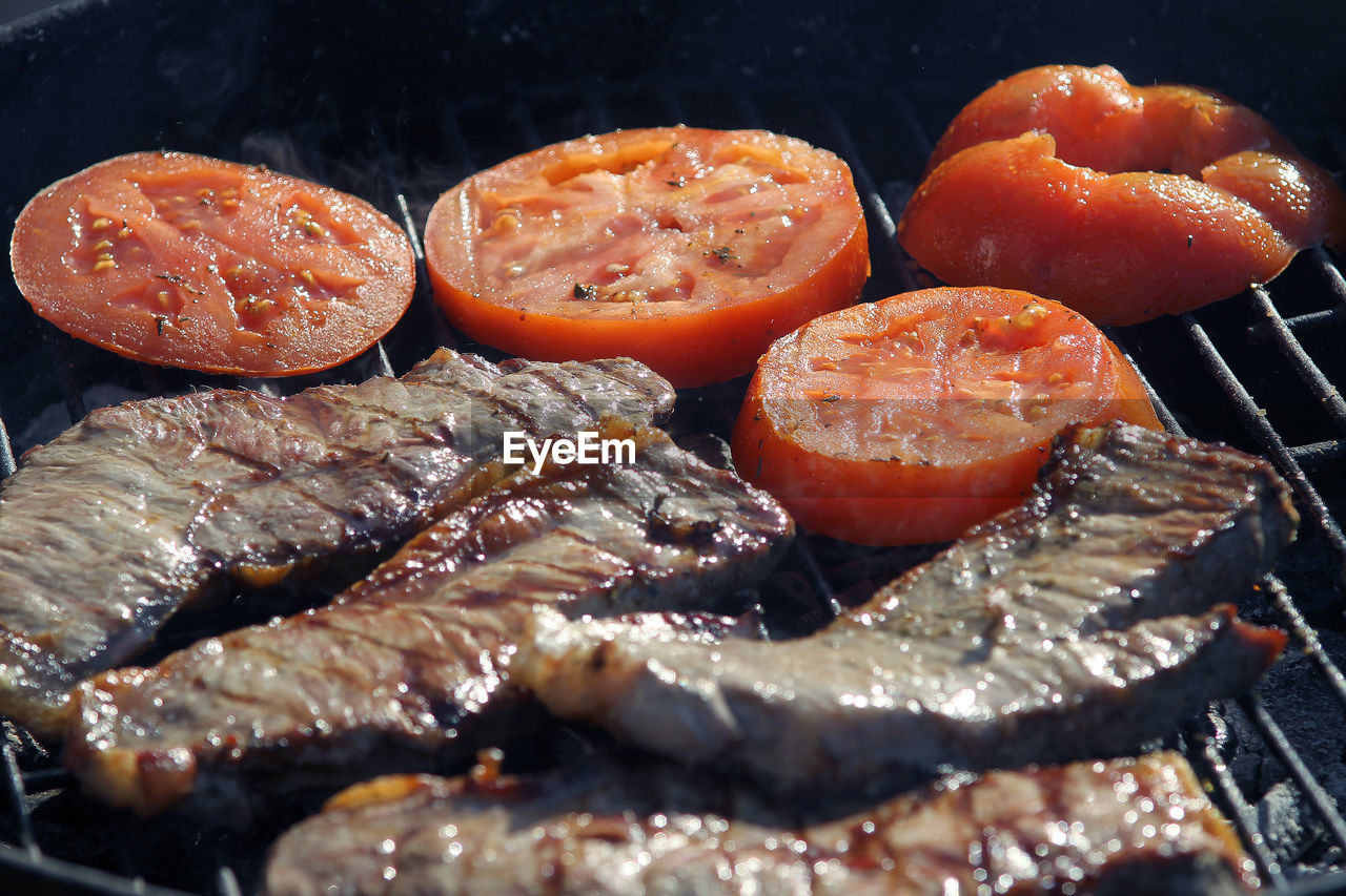 CLOSE-UP OF MEAT ON BARBECUE