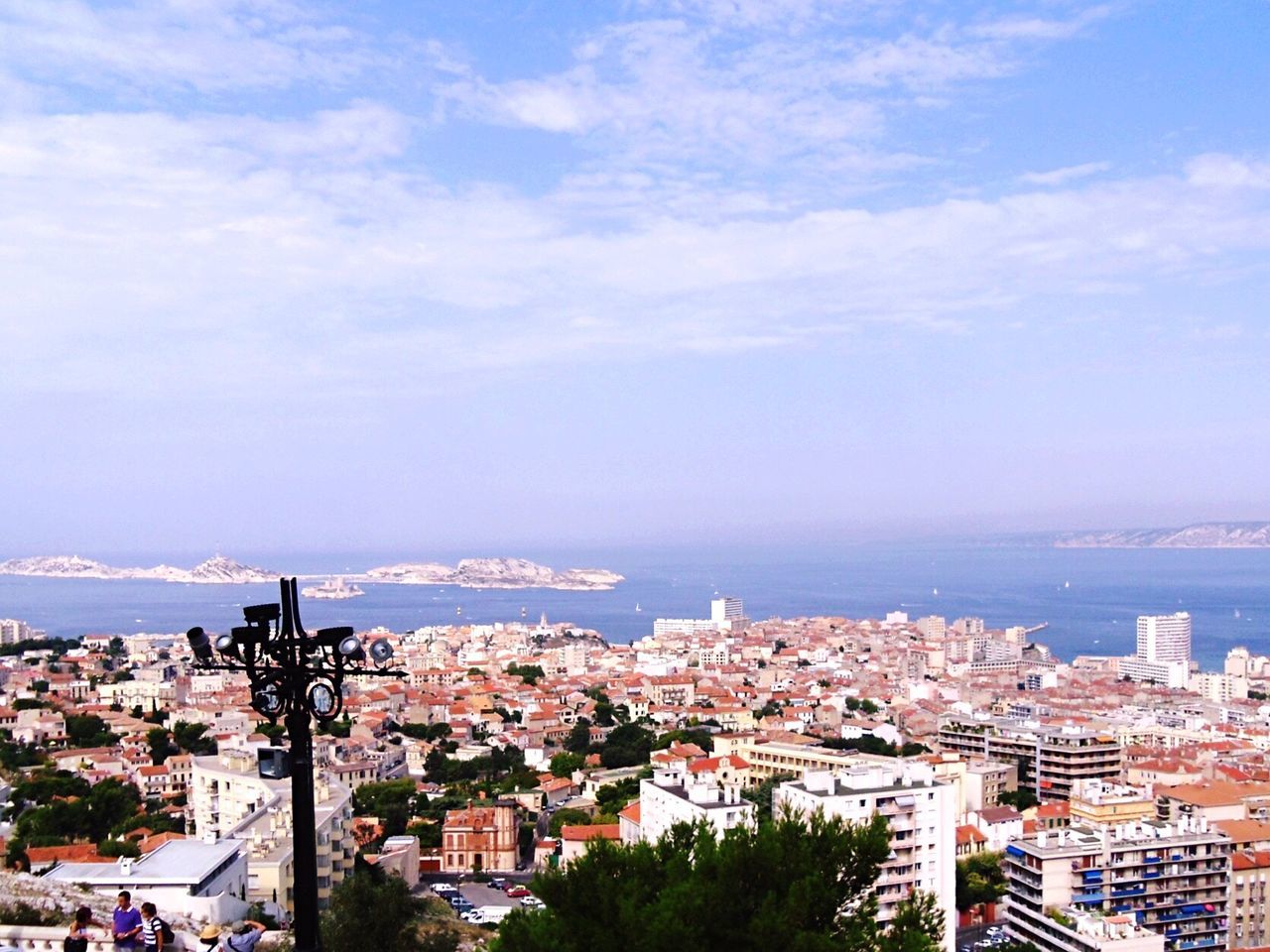 High angle view of cityscape by sea against sky