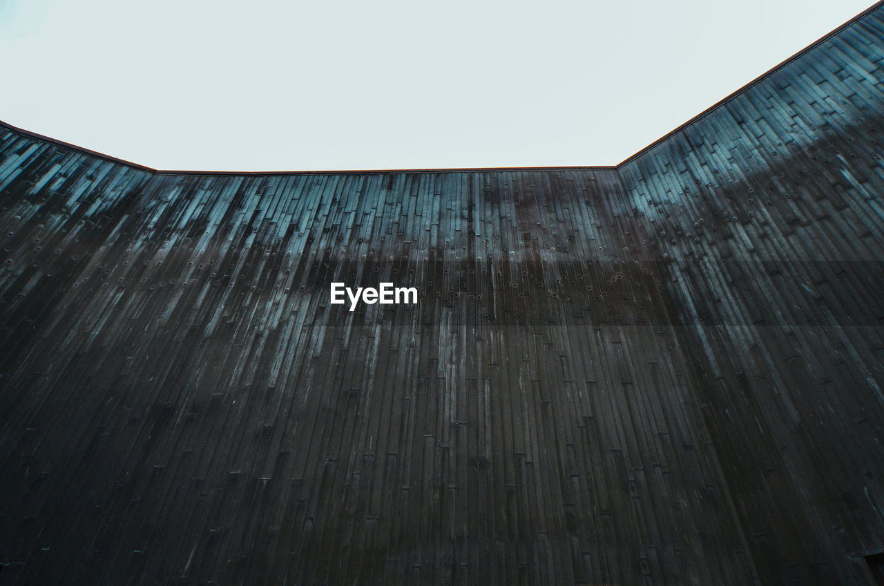 Low angle view of wall against clear sky