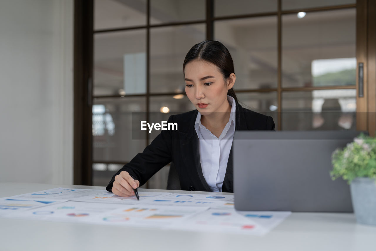 businesswoman using laptop on table